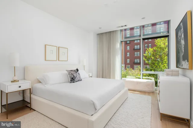 a bedroom with a large bed and a large window