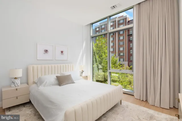 a bed sitting in a bedroom next to a window