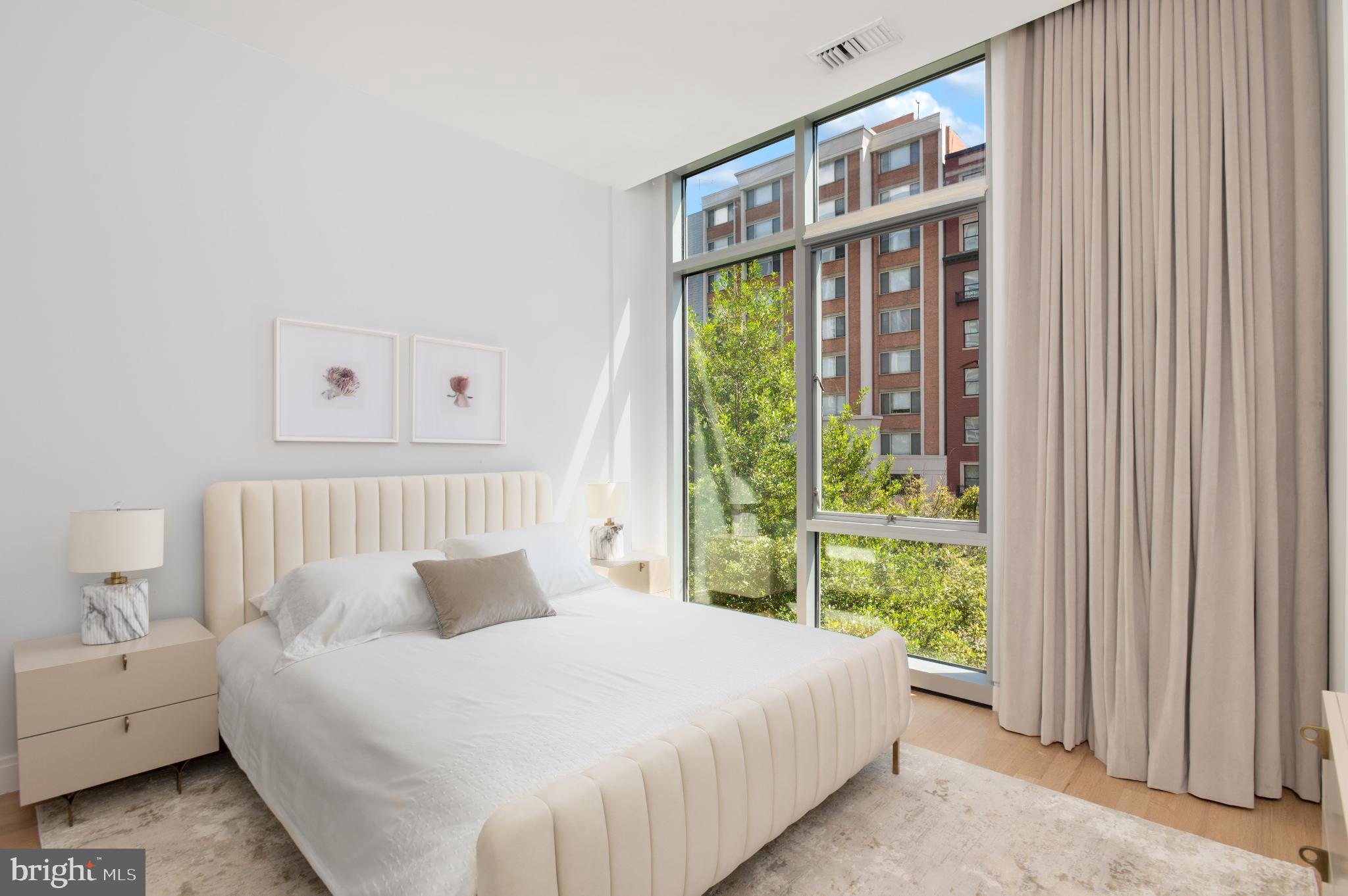 1177 22nd Street Northwest, Unit 2K Washington, DC 20037 - Photo 10 of 21 a bed sitting in a bedroom next to a window