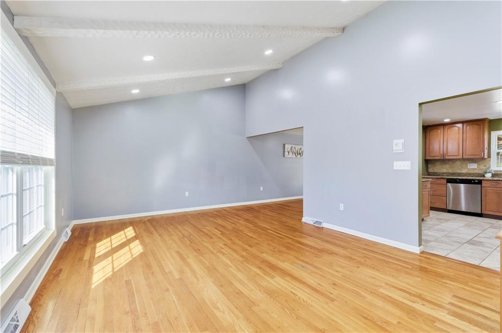 174 North Jamestown Road Coraopolis, PA 15108 - Photo 4 of 27 a view of empty room with wooden floor and kitchen