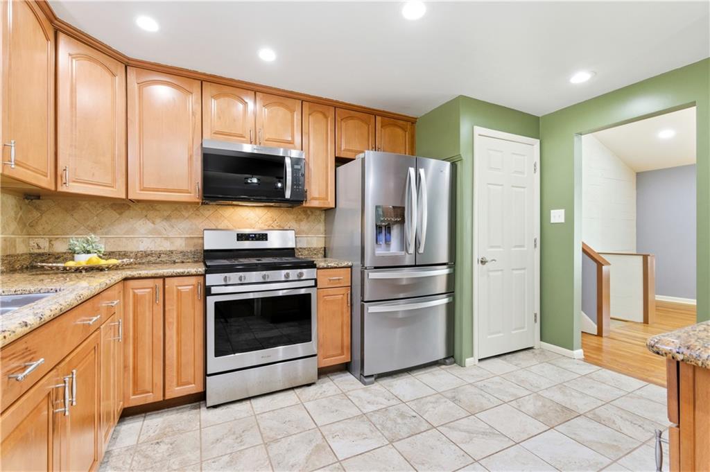 174 North Jamestown Road Coraopolis, PA 15108 - Photo 10 of 27 a kitchen with granite countertop a refrigerator and a stove top oven