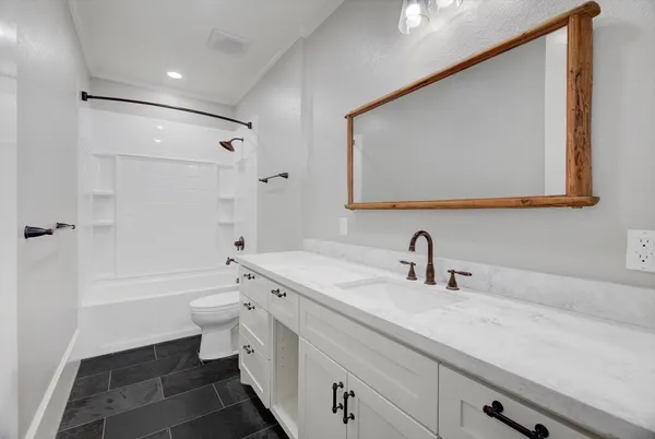 a bathroom with a sink a toilet and a bathtub