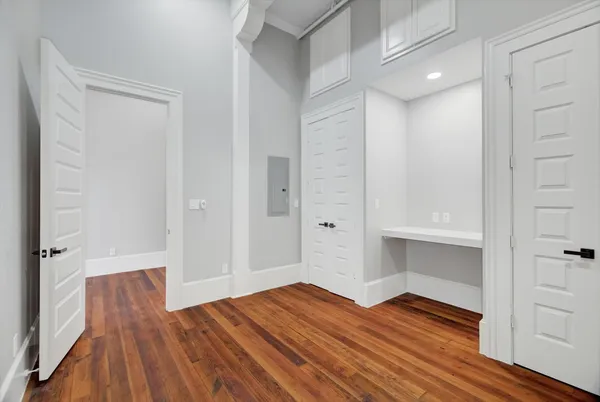 a view of empty room with wooden floor