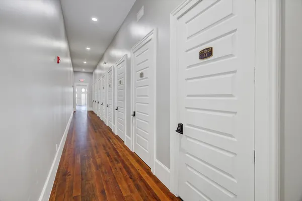 a view of a hallway with wooden floor