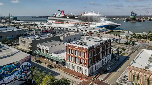 an aerial view of a house with balcony and ocean view