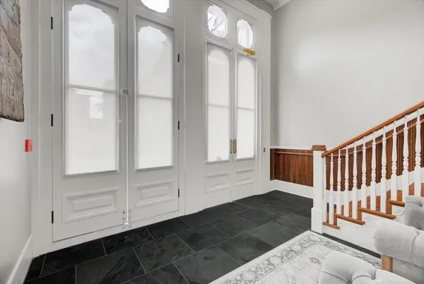 a view of a hallway with entryway wooden floor and front door