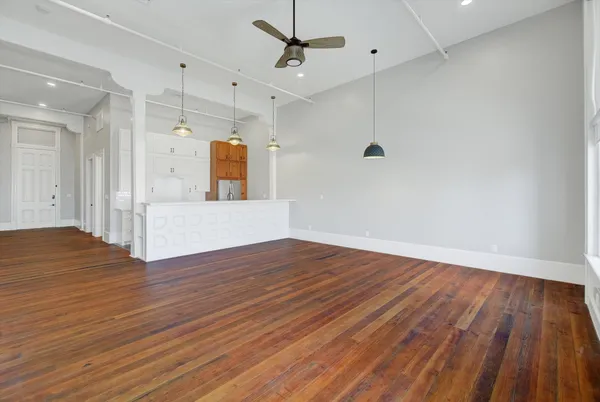 a view of a room with wooden floor