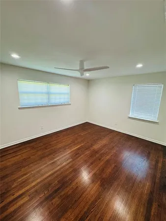 a view of a room with wooden floor and white walls