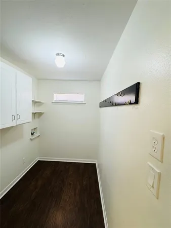 a view of storage and utility room with wooden floor