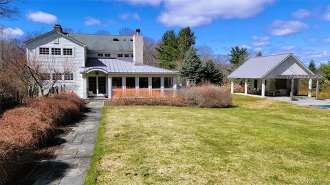 a view of a patio with furniture and a yard