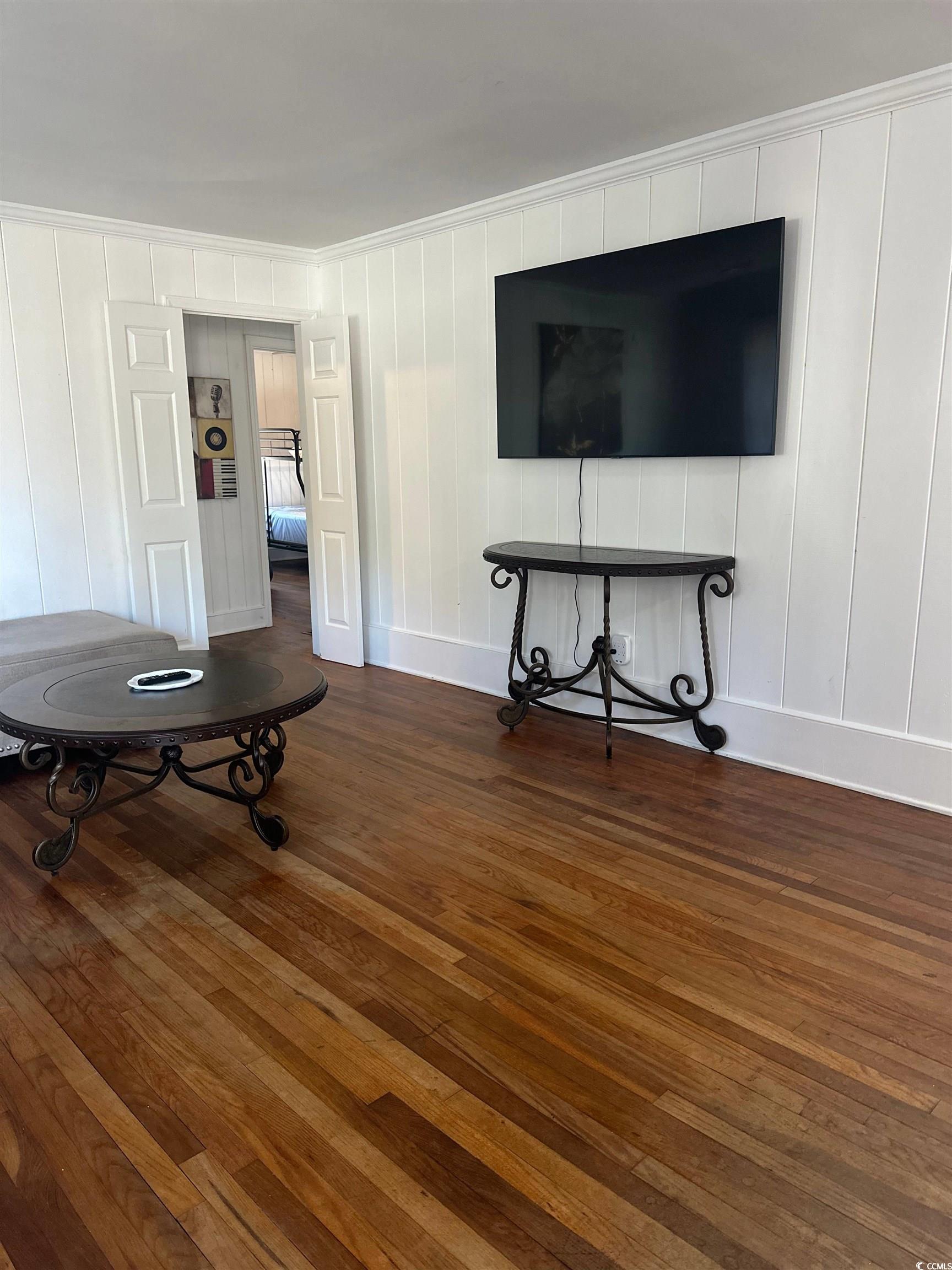 519 32nd Avenue North Myrtle Beach, SC 29577 - Photo 13 of 25 Living room featuring dark wood-type flooring and crown molding