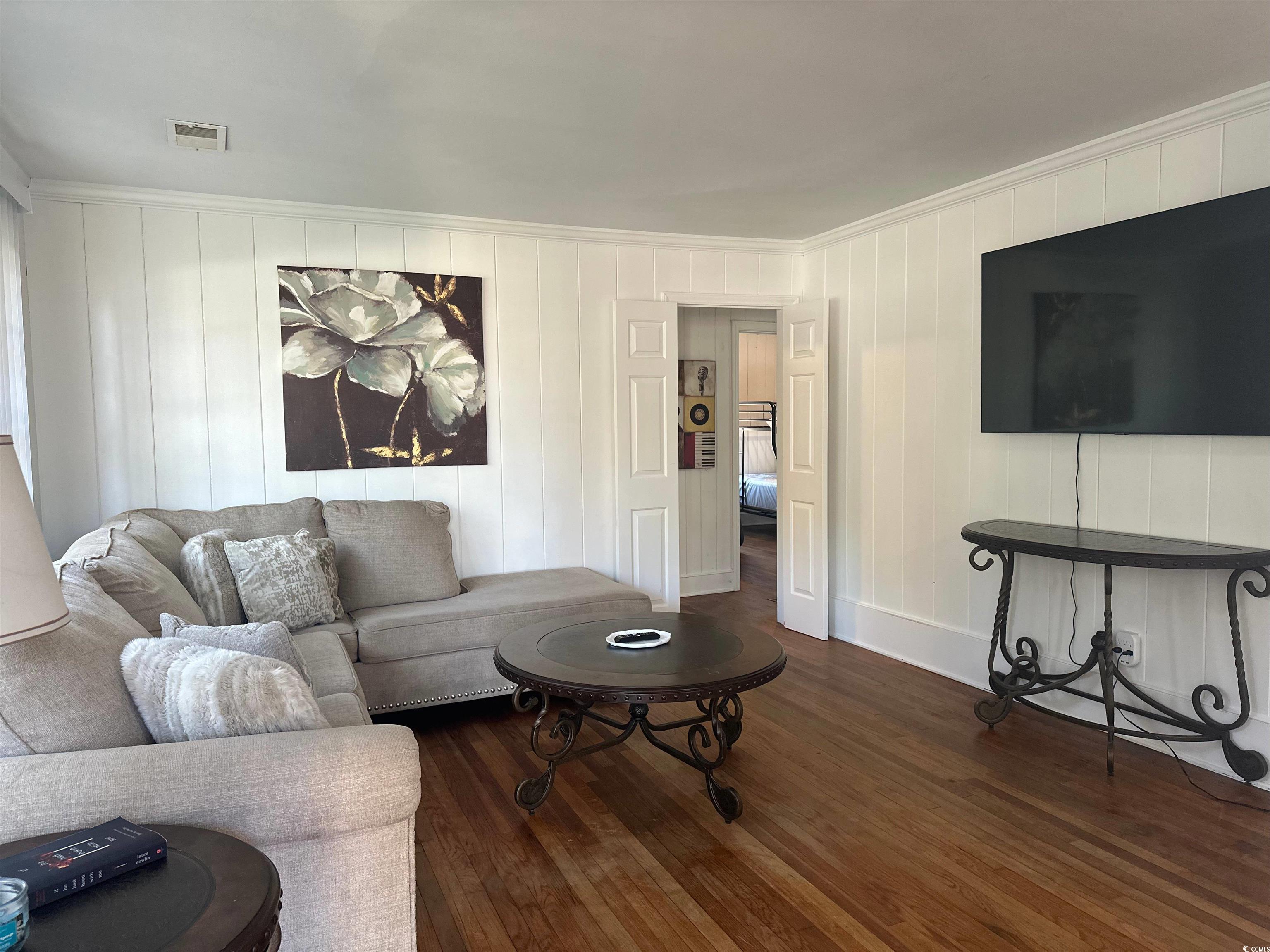 519 32nd Avenue North Myrtle Beach, SC 29577 - Photo 10 of 25 Living room with dark wood finished floors and crown molding