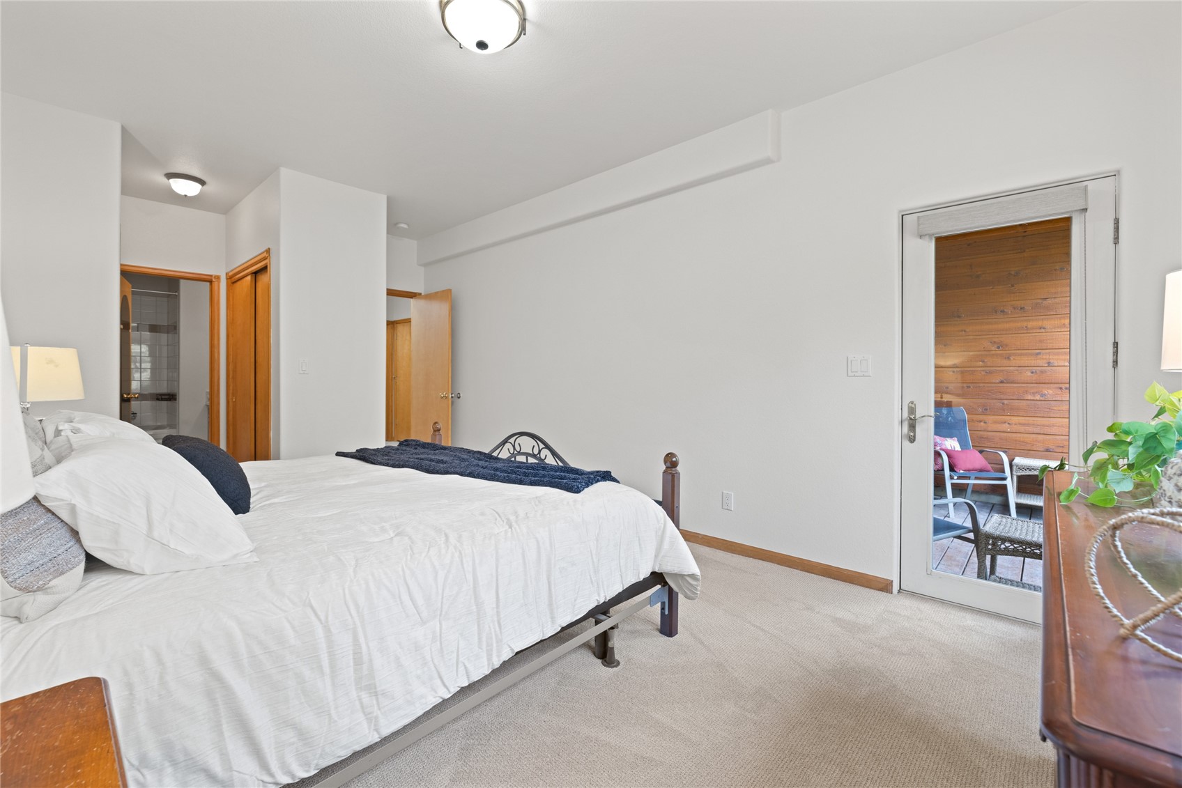 97 Lookout Ridge Drive, Unit 97 Dillon, CO 80435 - Photo 26 of 41 Primary bedroom with access door to the lower level deck and outdoor space