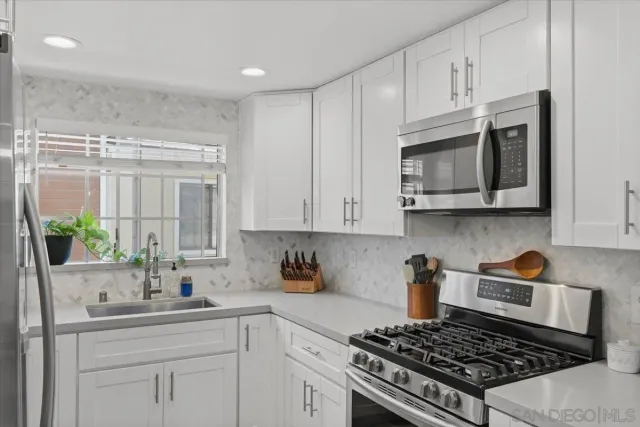 a bathroom with a shower sink vanity mirror and toilet