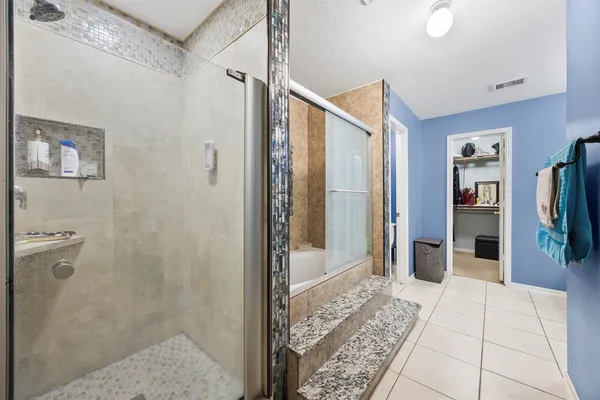 a bathroom with a shower and a sink