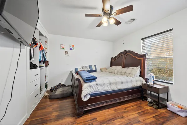 a bedroom with a bed closet and a window
