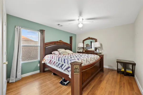 a bedroom with a bed and a large mirror