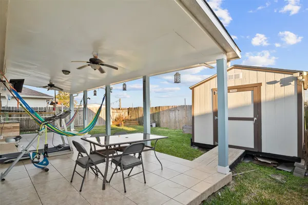 a view of a patio with a table and chairs