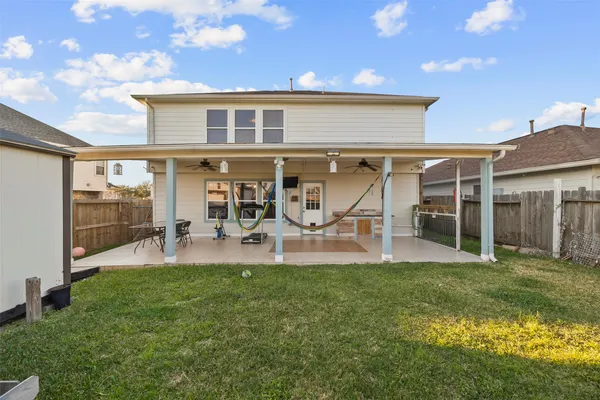 a view of a house with a yard and sitting area