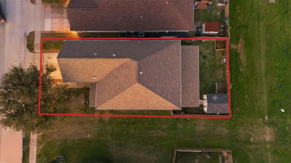 an aerial view of residential houses with city view