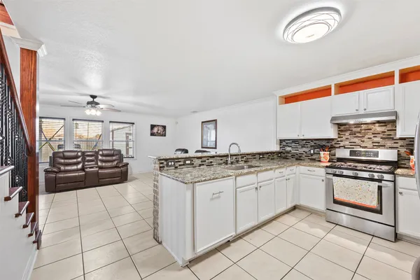 a kitchen with stainless steel appliances granite countertop a stove and a sink