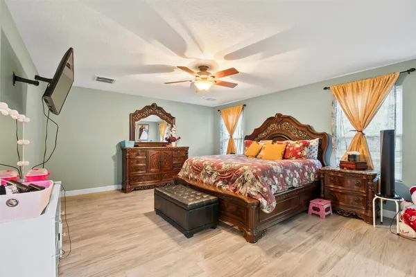 a bedroom with a bed dresser and a window