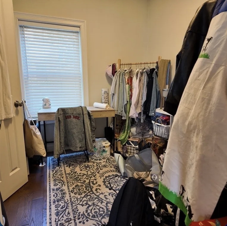 7 Loring Street, Unit 2 Boston, MA 02127 - Photo 8 of 10 a view of walk in closet with clothes and shoes