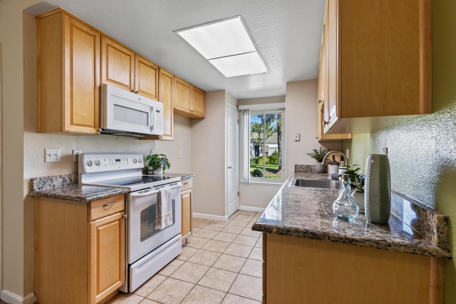 1313 Floyd Avenue, Unit 179 Modesto, CA 95355 - Photo 12 of 28 a kitchen with stainless steel appliances granite countertop a sink stove and cabinets