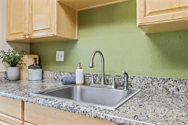 a view of a hallway with wooden floor and a livingroom