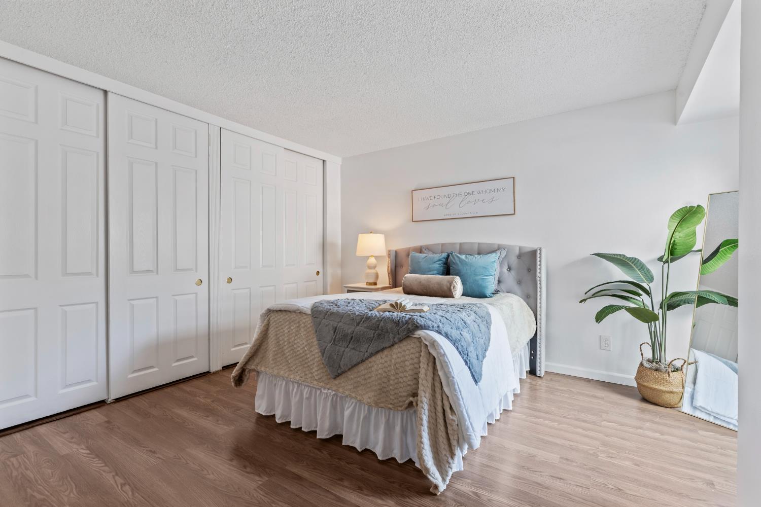 1313 Floyd Avenue, Unit 179 Modesto, CA 95355 - Photo 18 of 28 a spacious bedroom with a bed and wooden floor