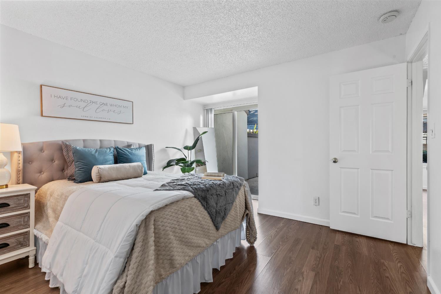 1313 Floyd Avenue, Unit 179 Modesto, CA 95355 - Photo 19 of 28 a bedroom with a bed and wooden floor