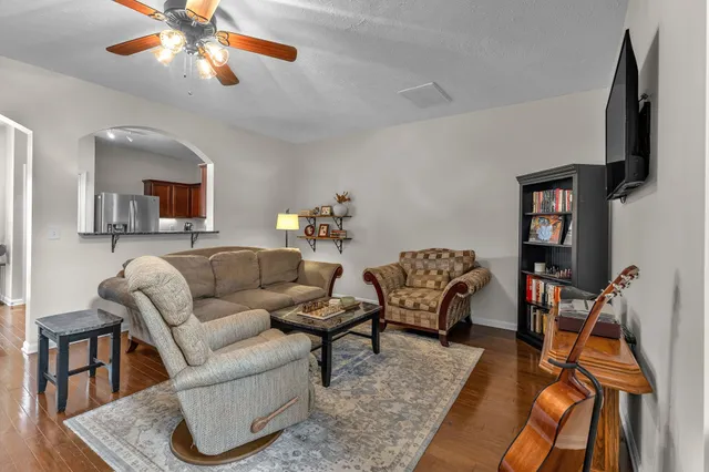 a living room with furniture a couch and wooden floor