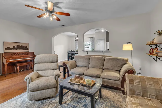 a living room with stainless steel appliances kitchen island granite countertop furniture and a kitchen view