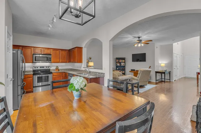 a kitchen with a sink dining table and chairs