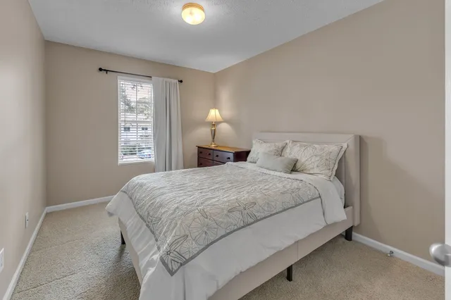 a bedroom with a bed and pillows