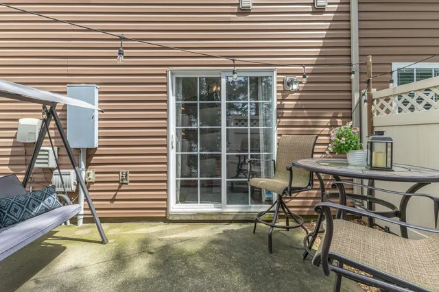 a view of a chairs and table in the balcony