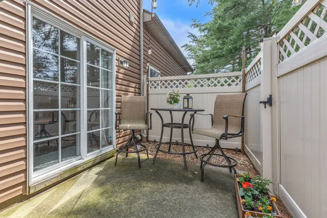a balcony with table and chairs