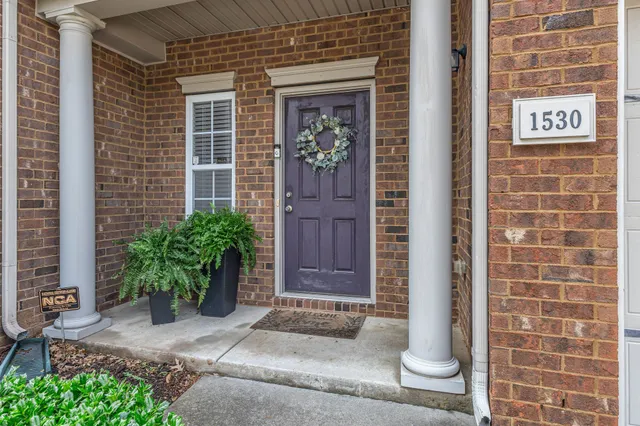 a view of a hallway with wooden floor and stairs