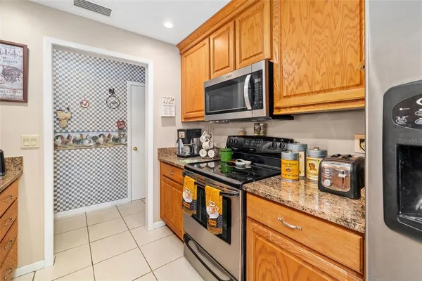 a kitchen with stainless steel appliances granite countertop a sink stove and cabinets
