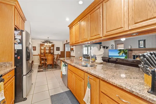 a living room with stainless steel appliances granite countertop furniture and a kitchen counter top