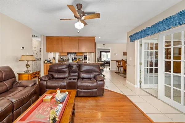 a living room with furniture a ceiling fan and a rug