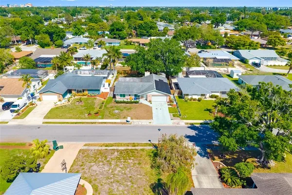 an aerial view of residential houses with outdoor space and swimming pool