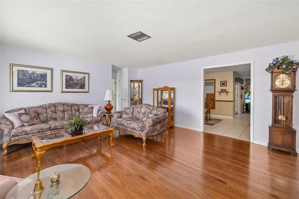 a dining hall with stainless steel appliances a dining table and chairs