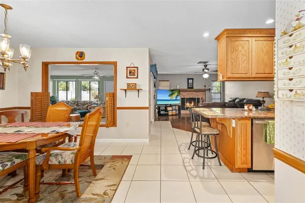 a dining room with furniture and chandelier kitchen view