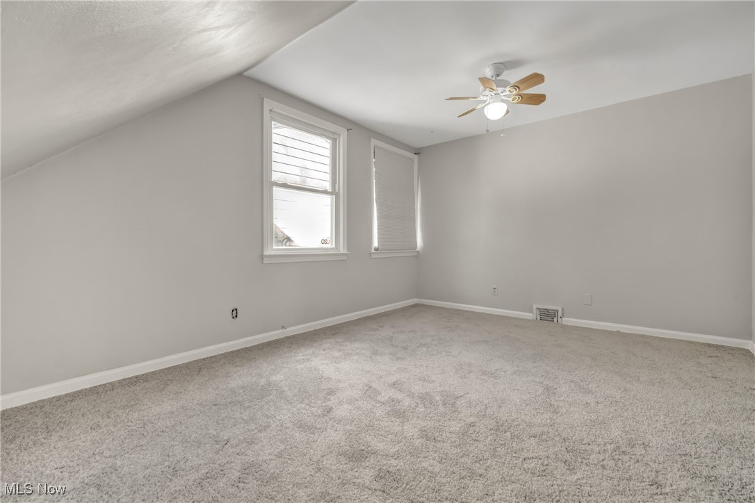 2440 White Road Cleveland, OH 44118 - Photo 33 of 43 Bonus room featuring lofted ceiling, carpet, and ceiling fan