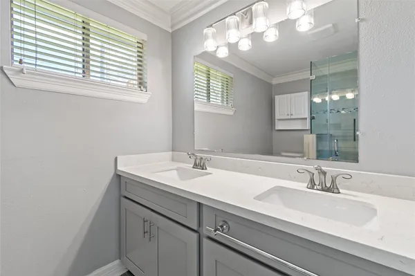 a bathroom with a sink double vanity and a mirror