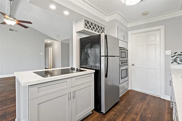 a utility room with cabinets washer and dryer