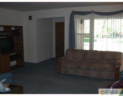 33 Meredith Road Piscataway, NJ 08854 - Photo 3 of 8 a living room with furniture and a flat screen tv