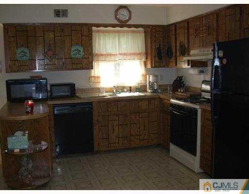 33 Meredith Road Piscataway, NJ 08854 - Photo 4 of 8 a kitchen with stainless steel appliances granite countertop a stove a sink and a refrigerator