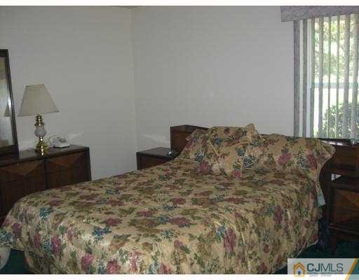 33 Meredith Road Piscataway, NJ 08854 - Photo 6 of 8 a bed sitting in a bedroom next to a window